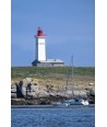 Les Glénan — phare rouge et blanc avec voilier amarré au pied